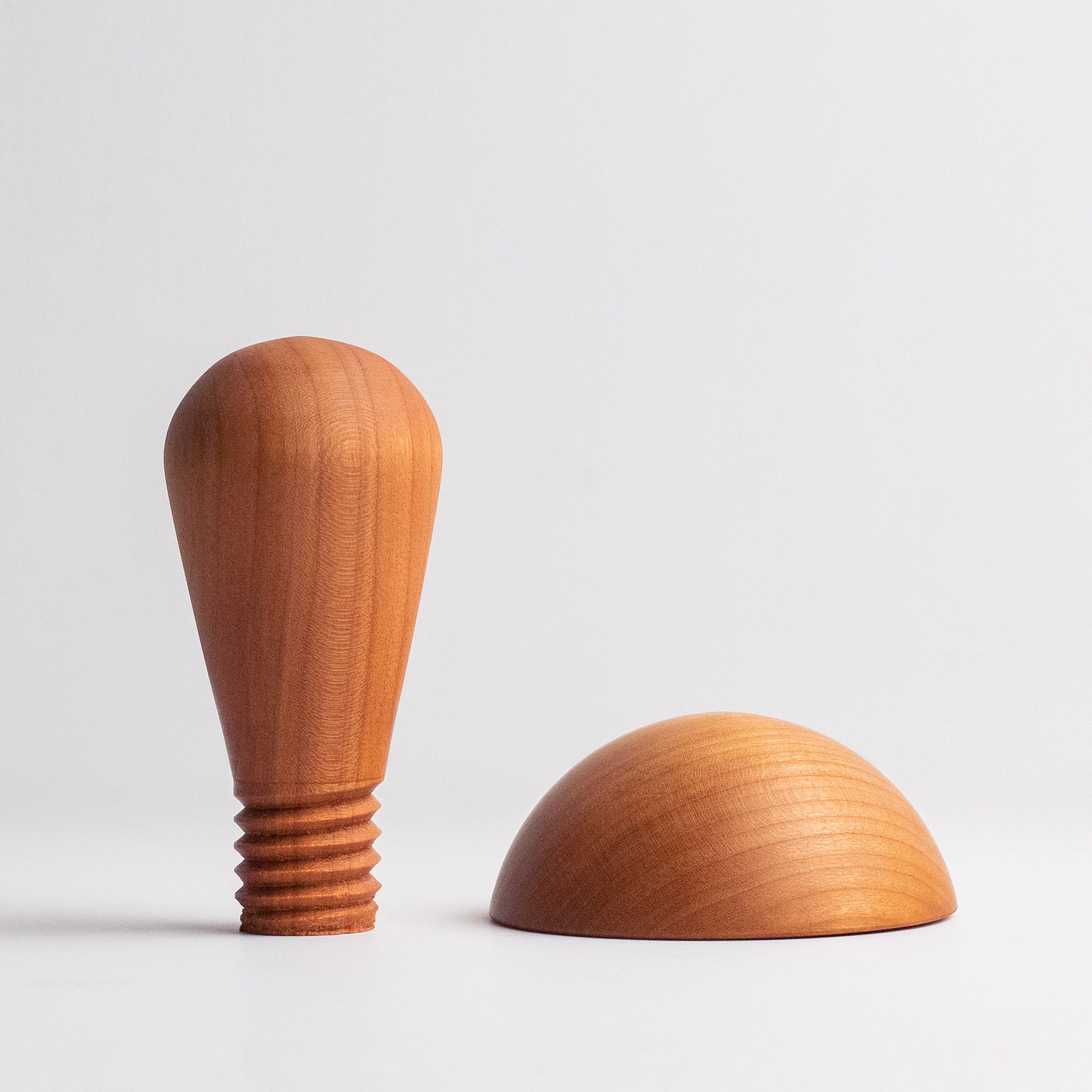 3" cherry wood mushroom anvil top placed next to a cherry wood handle in front of white background