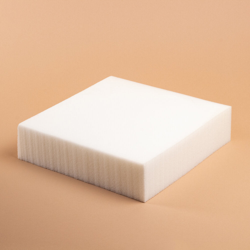 square, white piece of foam on pink background