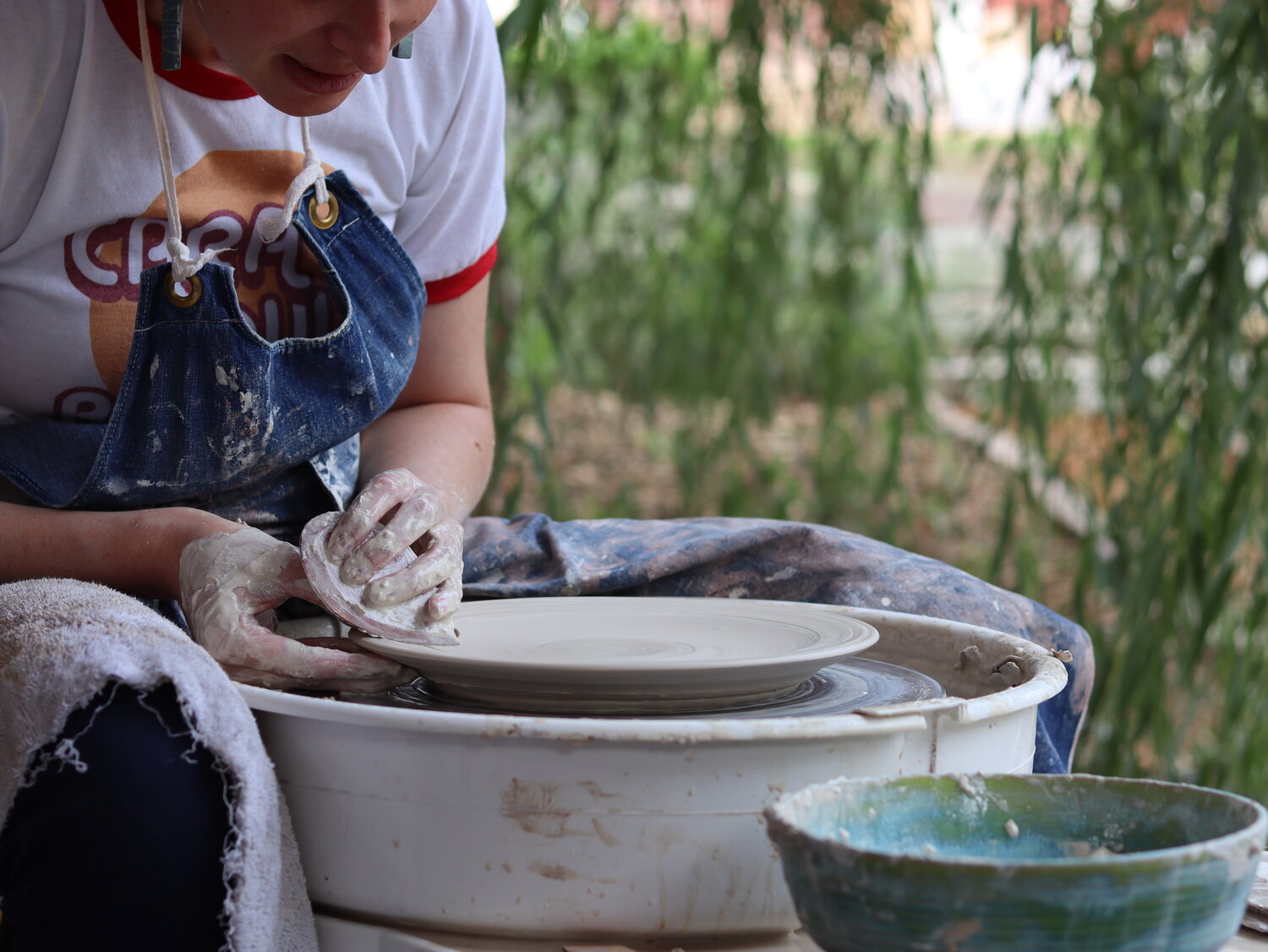 ceramicist uses Garrity Tools S2 pottery rib on clay plate