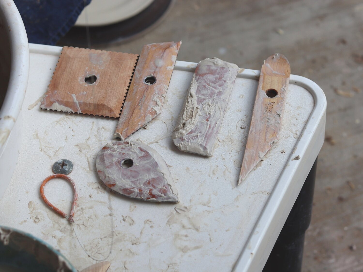 Garrity Tools wooden ribs covered in clay drying on a potter's wheel