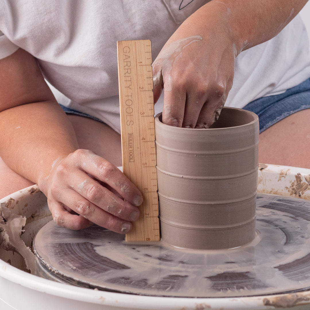 ceramicist uses Garrity Tools Ruler wooden pottery tool to measure clay vessel