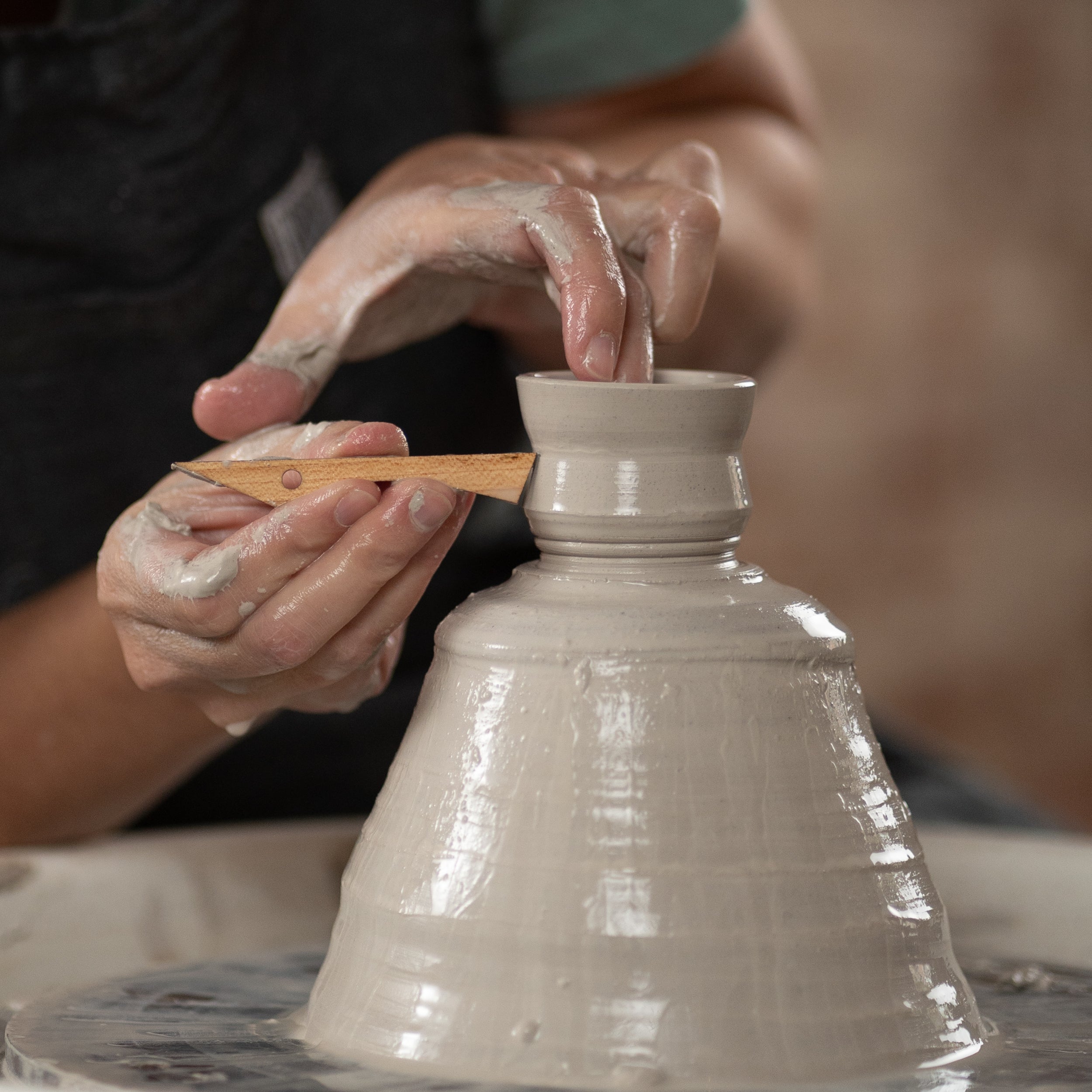 ceramicist uses tiny T1 pottery tool to throw off the clay hump