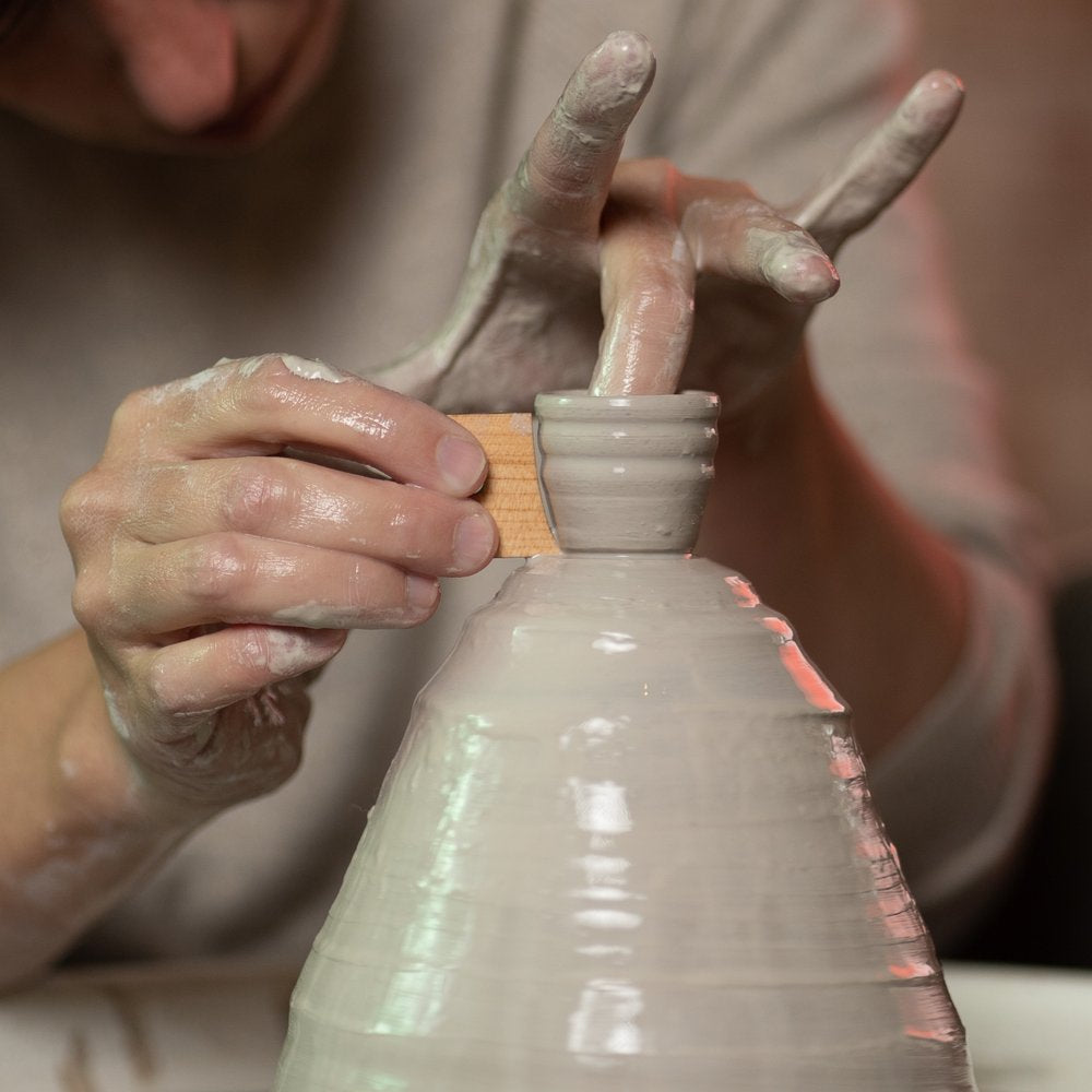 ceramicist uses tiny Unfoot 2 pottery tool to throw off the clay hump